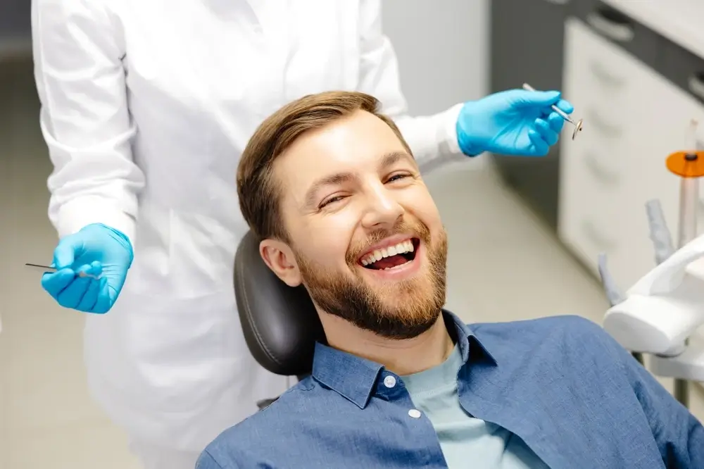 Man smiling in dentist chair during a checkup